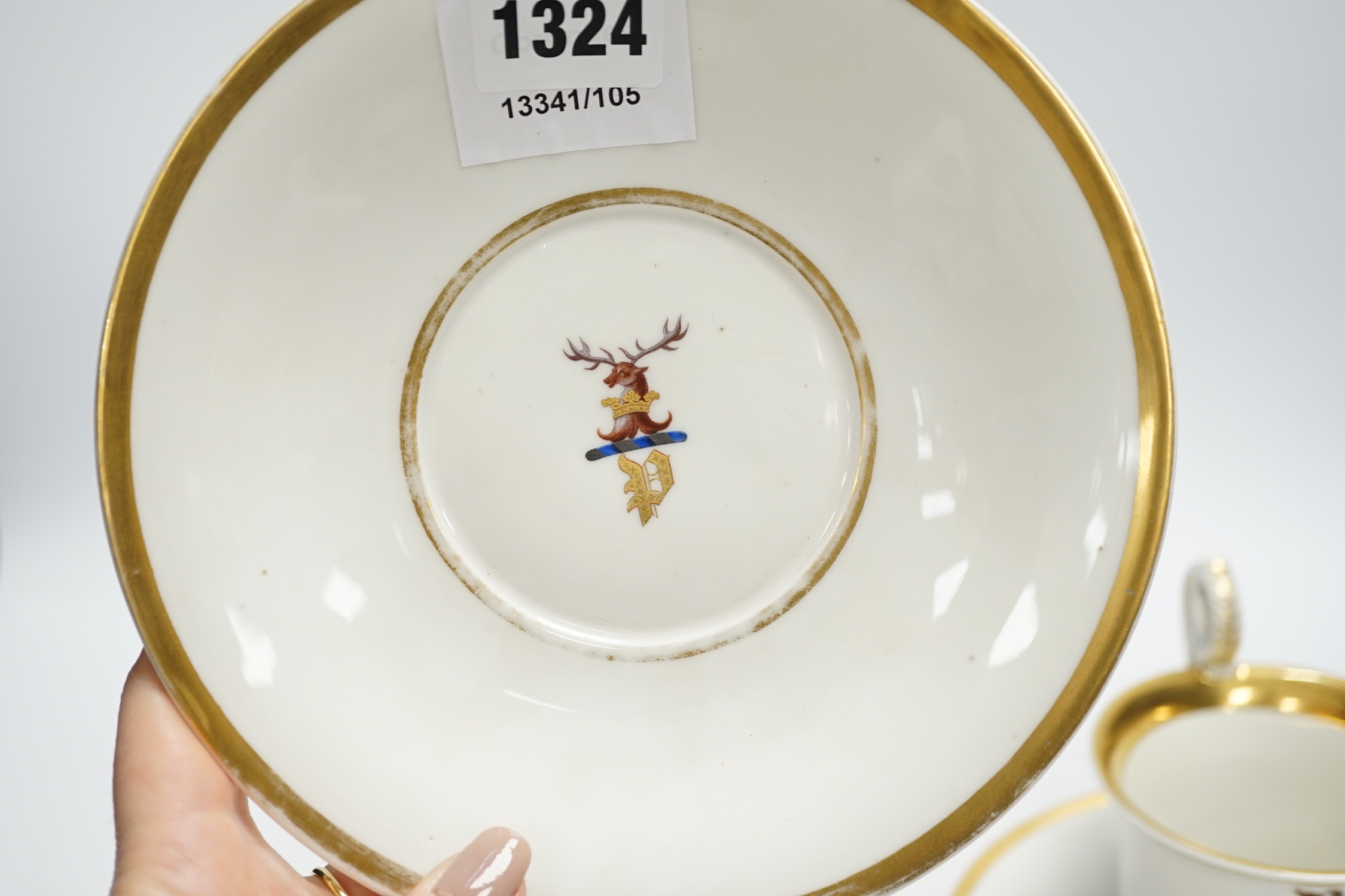 A pair of German porcelain armorial cups and saucers, one saucer reads ‘Lord Bingham s/m Y. Powell. Born 1848’